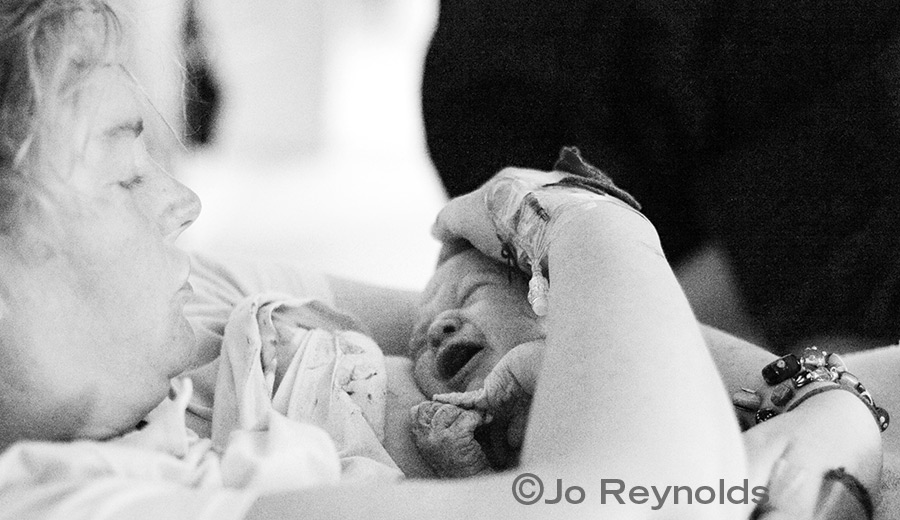 Mum has a cuddle with new baby